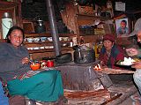 Manaslu 06 10 Syala Mother and Daughter In Lodge The campsite was already occupied by a Spanish group, so we stayed at the Maili Manaslu Hotel, Shyala, Gorkha. The lodge is being run by a mother and her daughter. The girl laughs liberally while mom sits silent, but smiling. I ate my dinner of rice and vegetable curry (hey, this isn't daal baht, is it), I watched as the girl cut mini-potatoes and fried them in a cast iron type pan on a small wood stove. I told her that potatoes were my favourite. She offered me a bowl, which I gratefully accepted. They were fantastic, though a bit spicy.